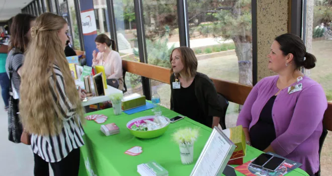 Representatives from Utica Park Clinic engage with TCC students at a job fair.